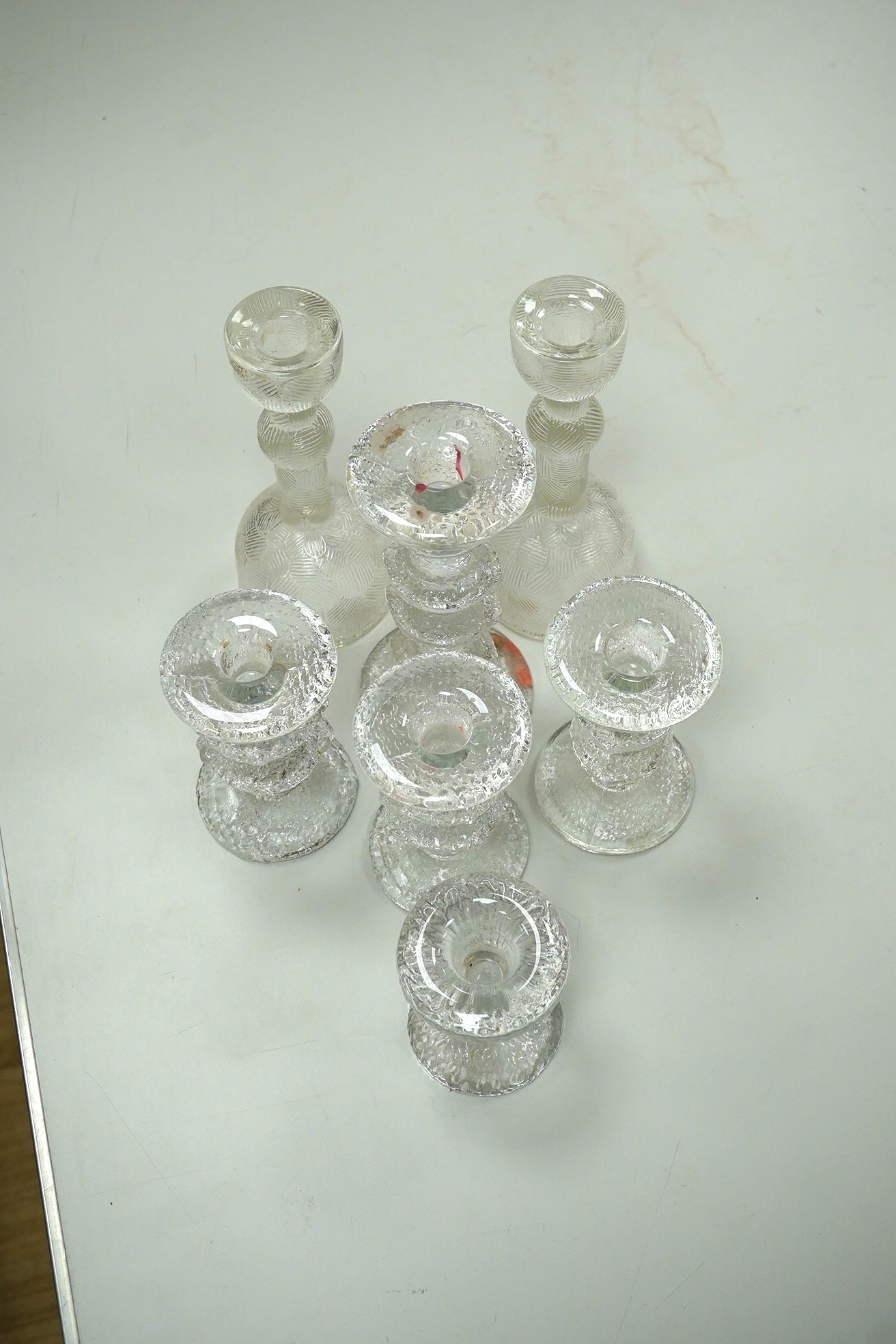 A group of Scandinavian clear glass candlesticks (7) including Timo Sarpaneva, tallest Arabia, 19.5cm high. Condition - good